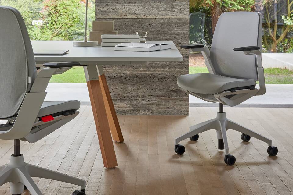 Ahrend Remode office chairs in grey and an Aero bench in a colaborative setting right side view