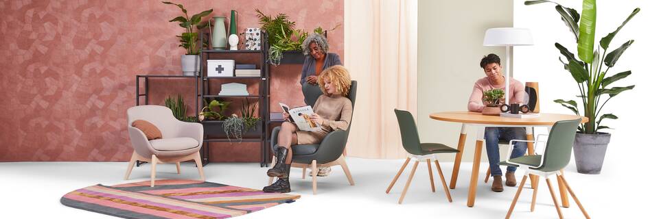 Gispen NOMI Wood chair with green upholstered cover and TEAM Wood round with Queen armchairs in care setting with models front view