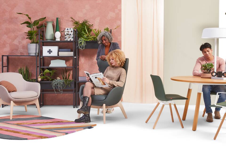Gispen NOMI Wood chair with green upholstered cover and TEAM Wood round with Queen armchairs in care setting with models front view