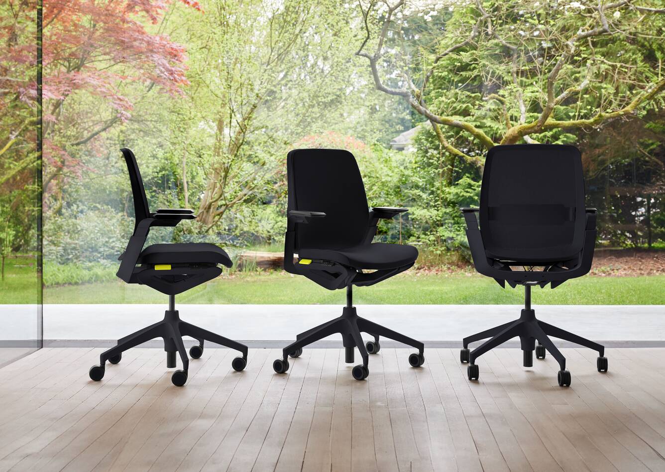 Ahrend Remode office chairs in black in different configurations with trees in background header front left side and rear view