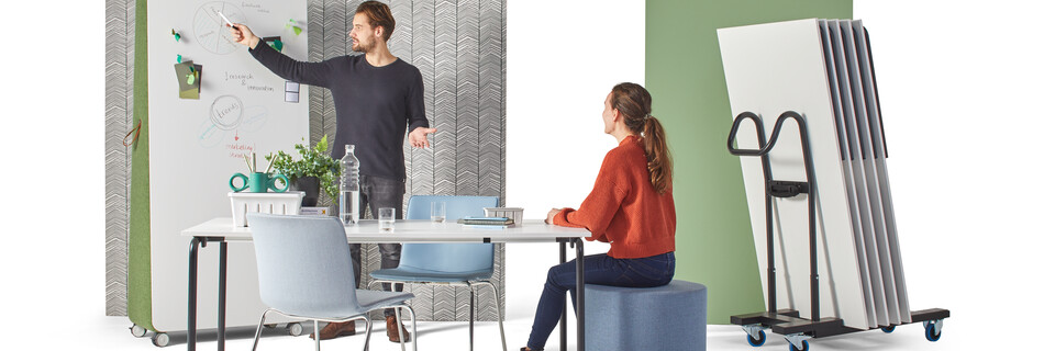 Gispen FLOO foldable table with black legs and white tabletop styled with NOMI Classic chairs and models with stacked tables on cart front view