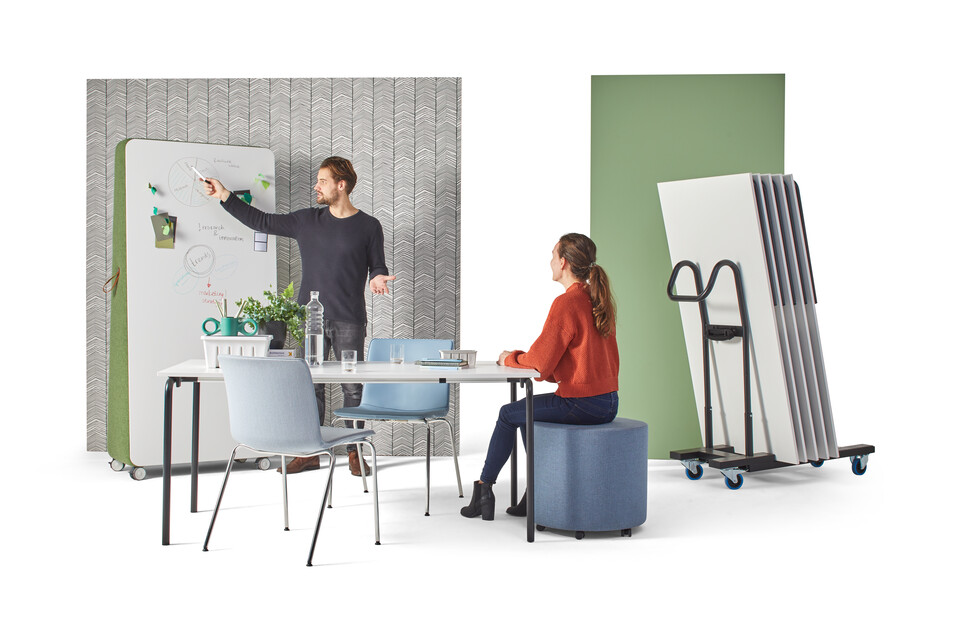 Gispen FLOO foldable table with black legs and white tabletop styled with NOMI Classic chairs and models with stacked tables on cart front view