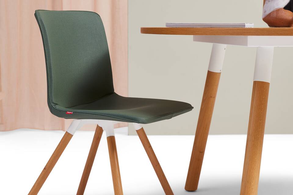 Gispen NOMI Wood chair in white with green upholstered cover and TEAM Wood round table in with and oak front left view