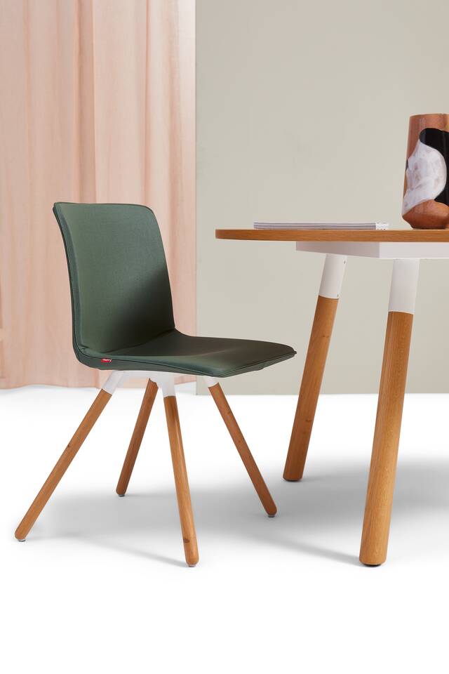 Gispen NOMI Wood chair in white with green upholstered cover and TEAM Wood round table in with and oak front left view