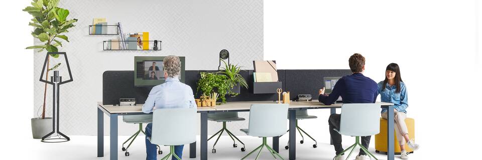 Gispen IC bench in blue with beech tabletop and NOMI Work chairs in blue with yellow Asido pouf and models and backpanels front left view