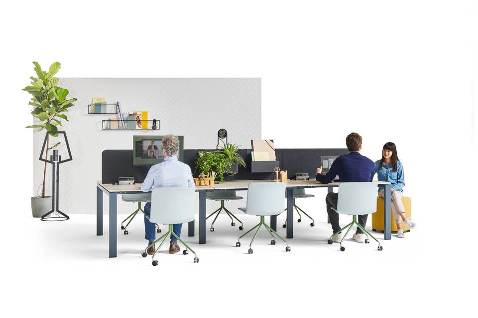 Gispen IC bench in blue with beech tabletop and NOMI Work chairs in blue with yellow Asido pouf and models and backpanels front left view