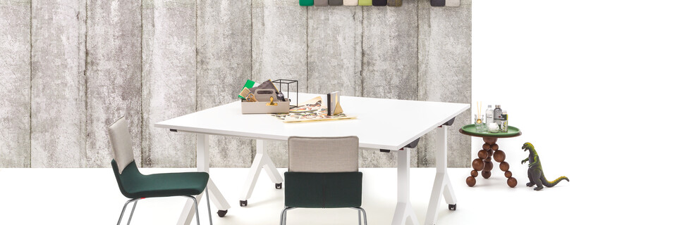 Gispen Dukdalf folding tables with Triennial Classic chairs and Bor sidetable with Asy serving tray in front of concrete backpanel front view