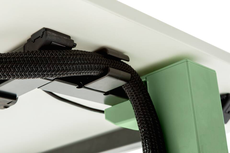 Gispen TMNL single workstation in green with cable tubing under white tabletop to frame left rear view