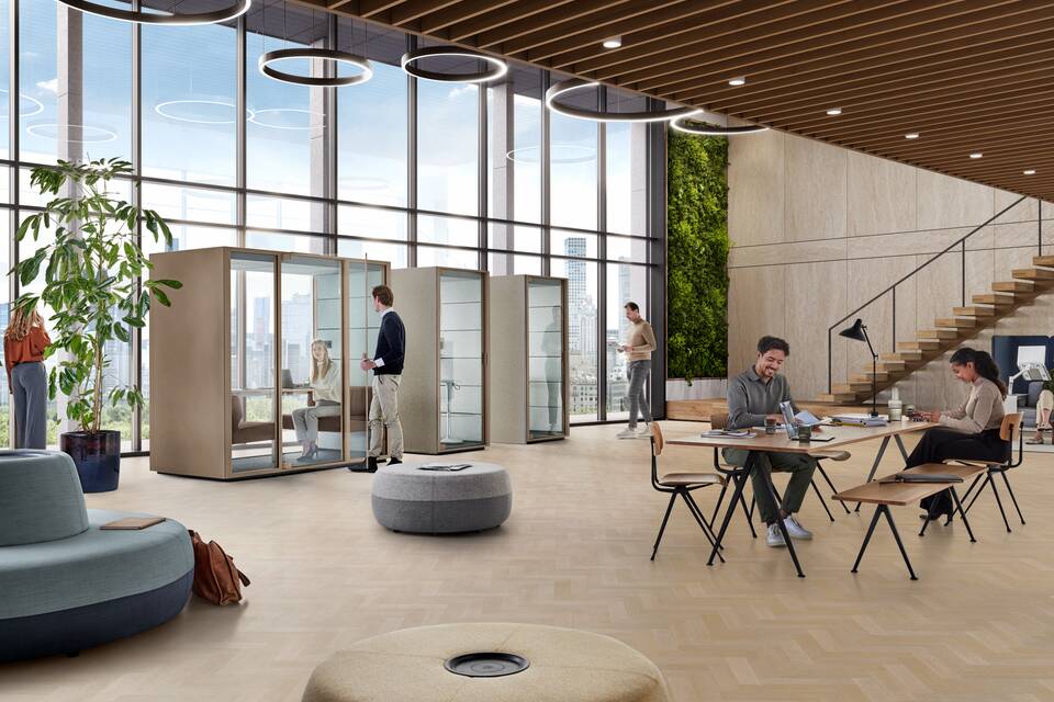 Ahrend Qabin Chat Lounge and Calls space in space in clay grey with models talking calling in a vitalising workspace interior view