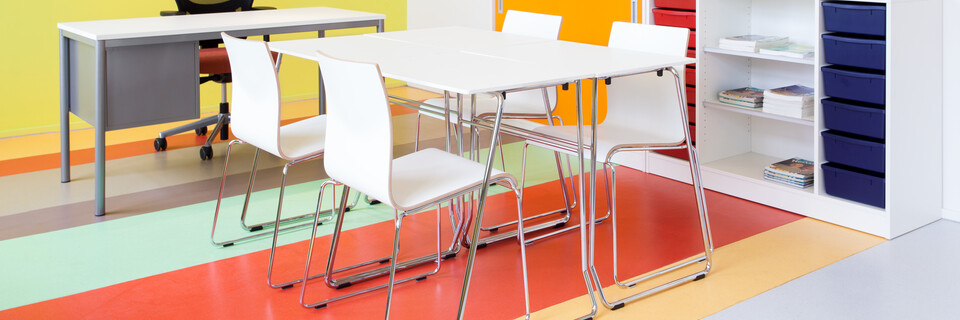 456, 370 Royal Ahrend 456 seminar tables with chrome frame and white tops with 370 wireframe chairs in classroom front right view
