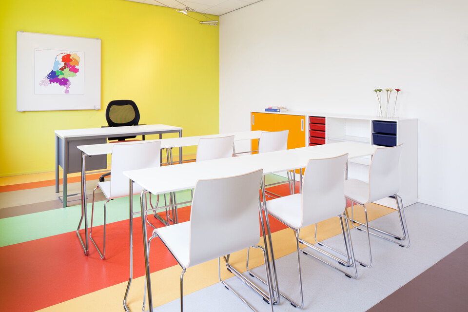 456, 370 Royal Ahrend 456 seminar tables with chrome frame and white tops in 2 rows of 3 with 370 wireframe chairs in classroom rear left view