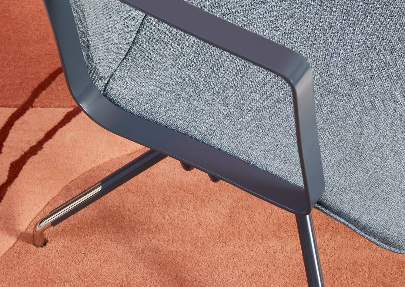 Gispen NOMI Work chair in blue with armrests and blue upholstered cover styled on carpet top left detail view