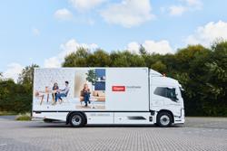 Gispen truck in white with Nomi visuals and logo with payoff left side view