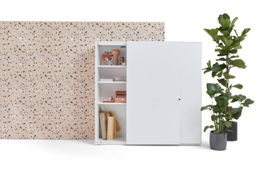 Gispen SDK sliding door cabinet high in white with left door partially open styled with backpanel front view