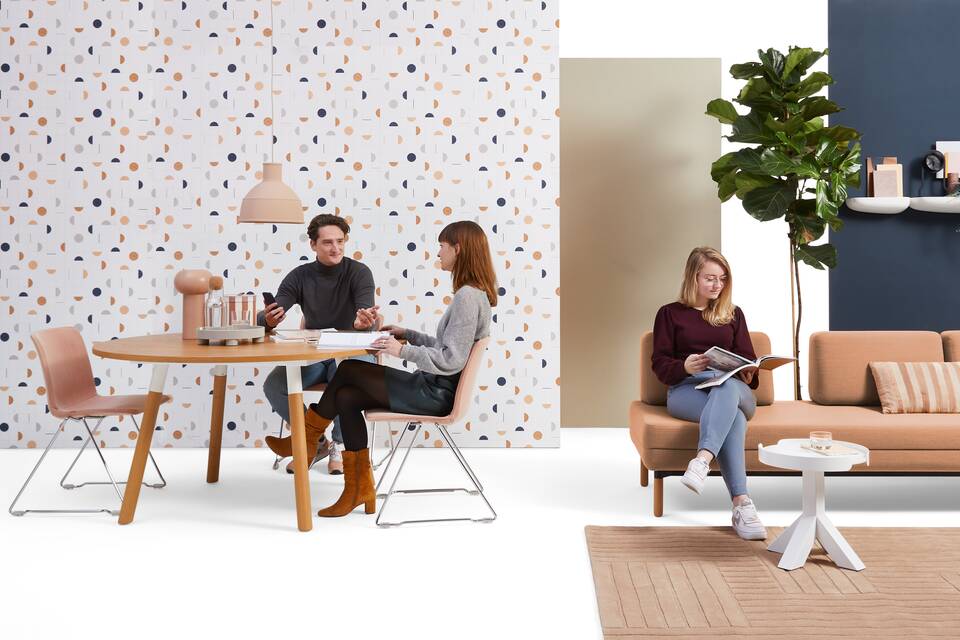 Gispen NOMI project chair with red upholstered cover and TEAM Wood round with STEE sofa in hospitality setting with own models front view